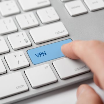 vpn services ipvanish finger on blue vpn key on white computer keyboard